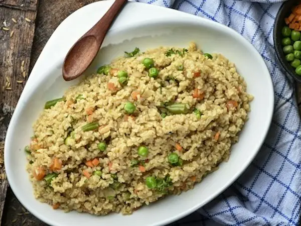 Freshly made poha garnished with coriander and lemon